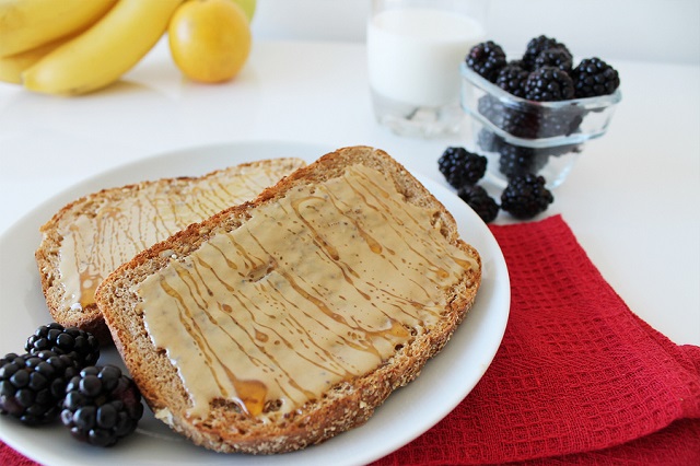 Toasted bread with sesame tahini and honey on a tablecloth. Breakfast concept